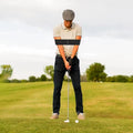 Golfer at address wearing the Unison Swing Band around both upper arms