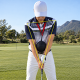 Golfer at address with the Unison Connection Ball held between his forearms, strap around the neck, keeping arms and chest connected
